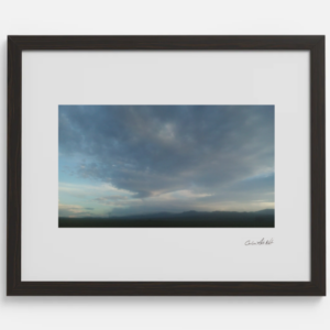 Decorative wall art Organic printed photo of sky with figure looking down in clouds